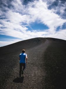 Image of man running up a hill to represent being driven